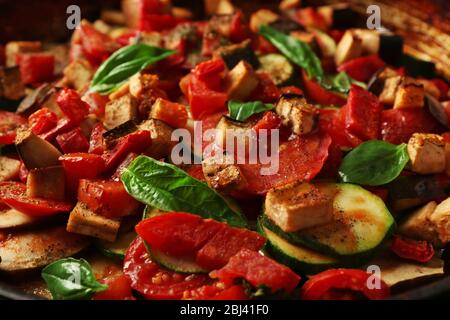 Tasty vegetarian ratatouille in black cast iron pan, close-up Stock Photo
