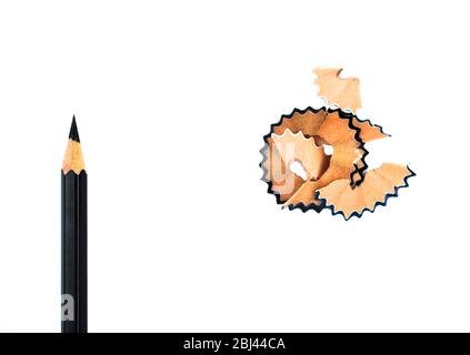 Top view of some pencil shavings placed beside a black color wood pencil crayon Stock Photo