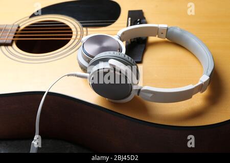 Classical guitar and headphones, close-up Stock Photo
