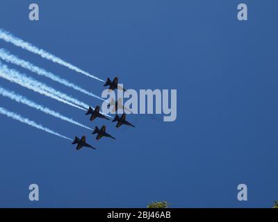 US Navy Blue Angels and US Air Force Thunderbirds over Newark, New Jersey USA on April 28th, 2020 in a tribute to the first responders and essential workers who have been on the front lines of the Covid-19 pandemic. Under a crystal clear blue sky the planes are seen over Newark, New Jersey's Sacred Heart Cathedral as they head north. Twelve aircraft in total passed seconds apart over the city. Photo credit: Tom Cassidy/ Alamy Stock Photo