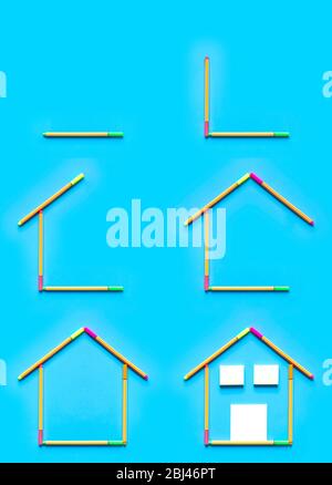 Top view of sticky notes and fluorescent marker pens forming a drawing of a house on pastel blue background, space for text. Construction and housing Stock Photo