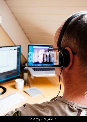 Man in home office having a video call with a colleague. Stock Photo