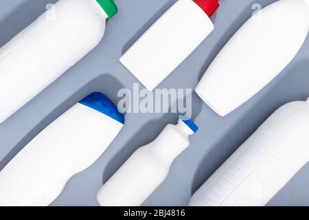 Group of white plastic bottles on gray background. Plastic recycling background. Top view Stock Photo