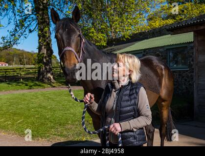 Camptoun, East Lothian, Scotland, United Kingdom. 28th Apr, 2020. A community in lockdown: residents in a small rural community show what life in lockdown is like for them. Pictured: Lorna and one of her three horses, Colin. Lorna goes into work at a local golf course a few days a week and works from home the rest of the time