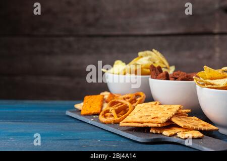 wide selection of snacks for beer on wooden background Stock Photo