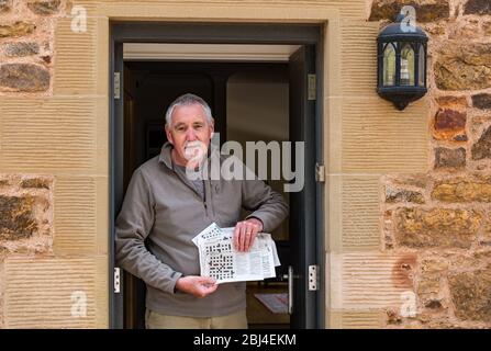 Camptoun, East Lothian, Scotland, United Kingdom. 28th Apr, 2020. A community in lockdown: residents in a small rural community show what life in lockdown is like for them. Pictured: Mike, retired and 67 years old, is a keen crossword solver, and has entered hundreds of crossword competitions