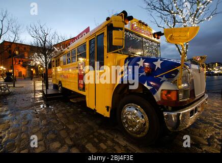 Liverpool, UK : Mar 16, 2019: An American style yellow school bus is used as a diner restaurant at the popular Royal Albert Dock tourist attraction in Stock Photo