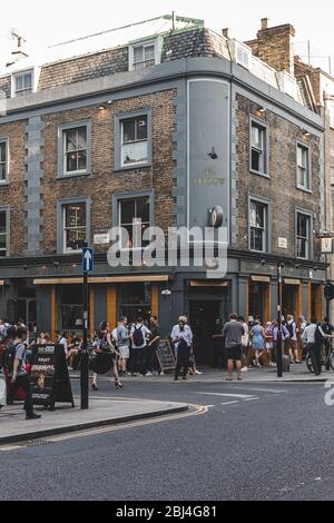 London/UK-26/07/18: people socializing just outside The Fellow Pub on York Way near King's Cross. Pubs are a social drinking establishment and a promi Stock Photo