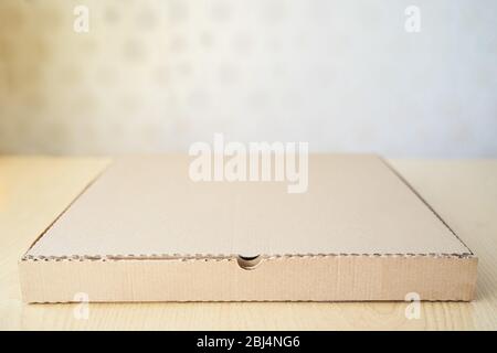 Blank brown cardboard Pizza paper box isolated on the table. Stock Photo