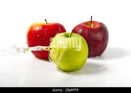 three apples with water splash. Three apples red, green, and yellow with warer splashes on white background Stock Photo