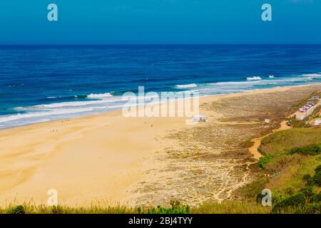 View of sandy North beach and blue Atlantc Ocean in Nazare, Portugal Stock Photo