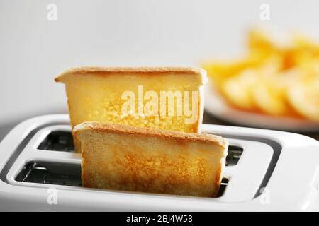 A couple of crusty toasts in the toaster, close-up Stock Photo