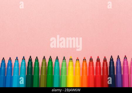 Assortment of colorful felt tip pens on pastel pink background Stock Photo