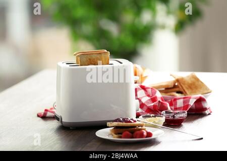 Served table for breakfast with toast and jam, on blurred background Stock Photo