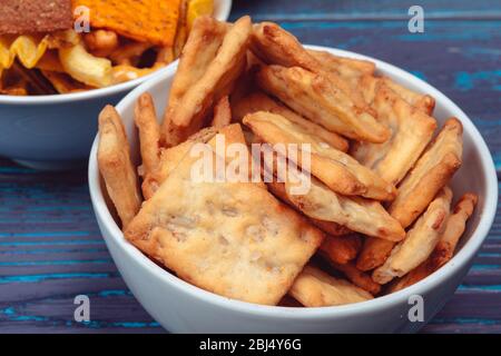 Differnt Types of Junk food, salty-sticks, salty-crackers on wooden table in still-life Stock Photo