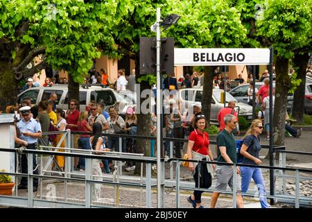 BELLAGIO, LAKE COMO - JUNE 2019: People walking along the gangway to board A passenger ferry at Bellagio on Lake Como. Stock Photo