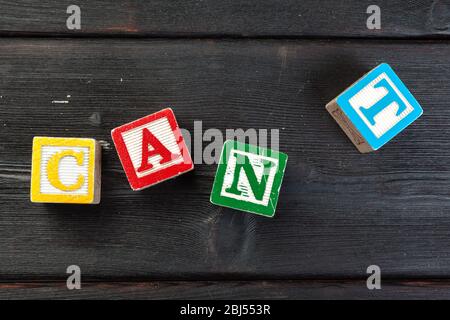 Can't Word Written In Wooden Cube on wooden background Stock Photo
