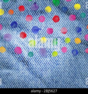 Denim jeans background with round frame made of watercolor rainbow blobs. Watercolor frame with colorful rainbow drops  on  jeans  texture Stock Photo