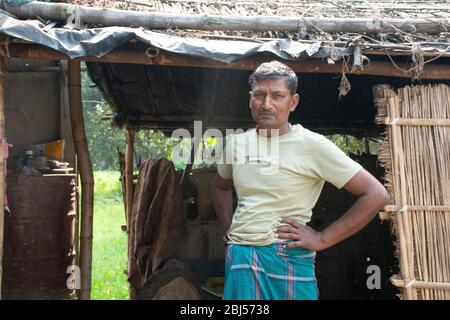 rural man standing in front of house Stock Photo
