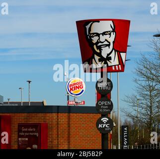 Dudley, United Kingdom - March 16 2020:  Signs for KFC and Burger King drive thru restaurants on Birmingham Road Stock Photo