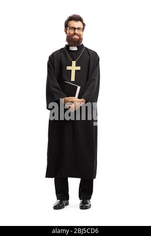 Full length portrait of a priest standing and holding the Bible isolated on white background Stock Photo