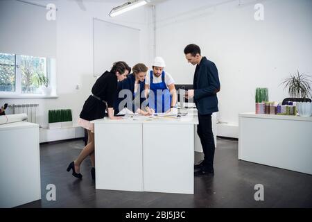 An architect team working on a project in a bright spacious office. Business Team Working Concept. Modern Open Space Office. Stock Photo
