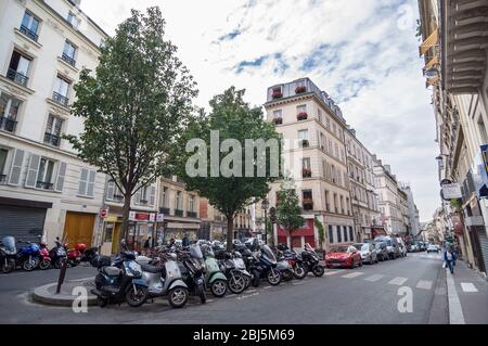 PARIS - SEPT 17, 2014: Motorcycles, mopeds and cars parked on the street Jean-Baptiste Pigalle. Paris, France. Stock Photo