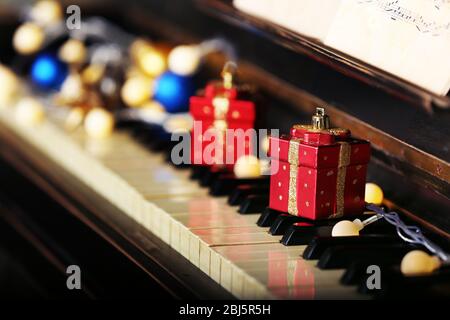 Piano keys decorated with Christmas decorations, close up Stock Photo