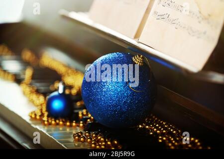 Piano keys decorated with Christmas decorations, close up Stock Photo