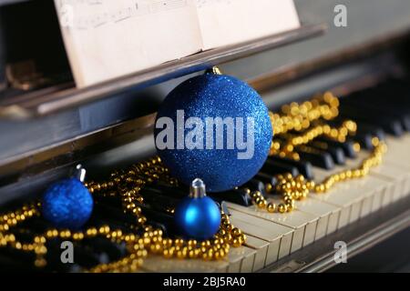 Piano keys decorated with Christmas decorations, close up Stock Photo