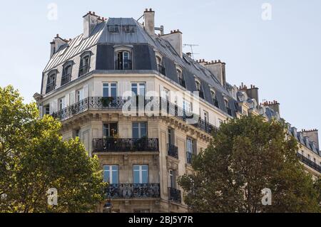 Typical design of Parisian architecture. The facade of french building in modern style with windows and french balconies in Paris, France. Stock Photo