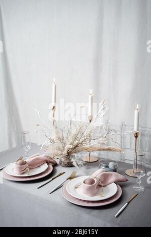 Setting easter table with candles and colored eggs Stock Photo