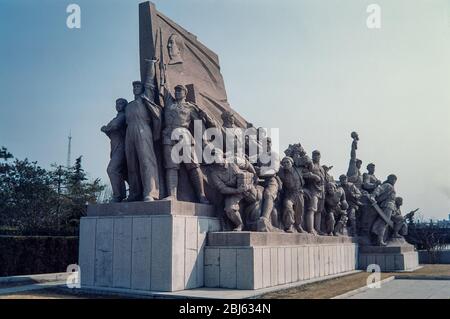 Beijing, China - Mar 1987: Statue of marching soldiers of the revolution in Tiananmen Square, Beijing, China.  Scanned 35mm film. Stock Photo