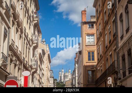 Basilique Notre Dame de Fourviere Basilica church in Lyon, France, seen from a nearby narrow street, surrounded by historic buildings of Presqu'Ile, i Stock Photo