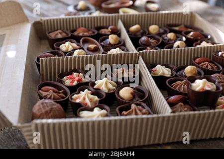 Different chocolate candies in paper box, close up Stock Photo