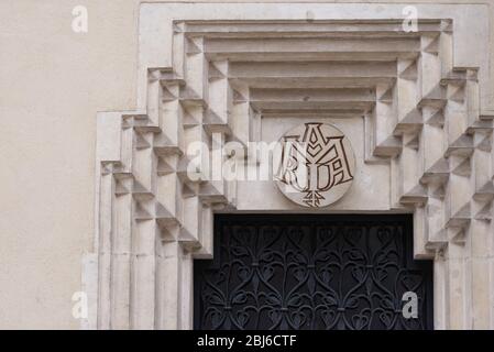 Bas-relief on one of the walls of Cracow. Coat of arms over the door in the Palace of Cracow. Stock Photo