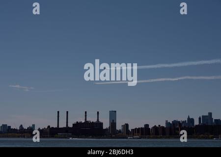 NEW YORK, NY - APRIL 28, 2020: The U.S. Navy's Blue Angels and U.S. Air Force's Thunderbirds jets perform a flyover New York City. Stock Photo