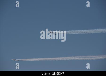 NEW YORK, NY - APRIL 28, 2020: The U.S. Navy's Blue Angels and U.S. Air Force's Thunderbirds jets perform a flyover New York City. Stock Photo