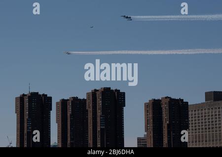 NEW YORK, NY - APRIL 28, 2020: The U.S. Navy's Blue Angels and U.S. Air Force's Thunderbirds jets perform a flyover New York City. Stock Photo