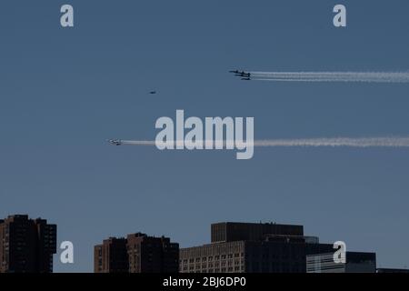 NEW YORK, NY - APRIL 28, 2020: The U.S. Navy's Blue Angels and U.S. Air Force's Thunderbirds jets perform a flyover New York City. Stock Photo