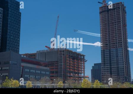 NEW YORK, NY - APRIL 28, 2020: The U.S. Navy's Blue Angels and U.S. Air Force's Thunderbirds jets perform a flyover New York City. Stock Photo