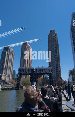 NEW YORK, NY - APRIL 28, 2020: The U.S. Navy's Blue Angels and U.S. Air Force's Thunderbirds jets perform a flyover New York City. Stock Photo