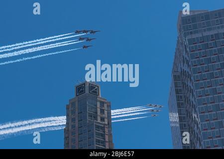 NEW YORK, NY - APRIL 28, 2020: The U.S. Navy's Blue Angels and U.S. Air Force's Thunderbirds jets perform a flyover New York City. Stock Photo