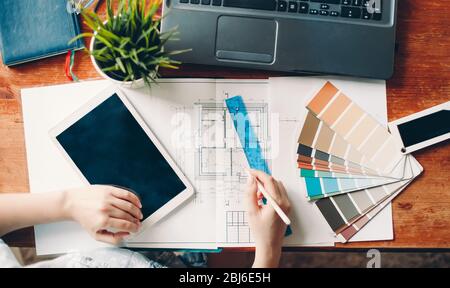 The desktop of the interior designer, the architectural plan of the house, the color palette. Drawings and plans for home decoration. top view color palette. Stock Photo