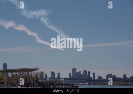 NEW YORK, NY - APRIL 28, 2020: The U.S. Navy's Blue Angels and U.S. Air Force's Thunderbirds jets perform a flyover New York City. Stock Photo