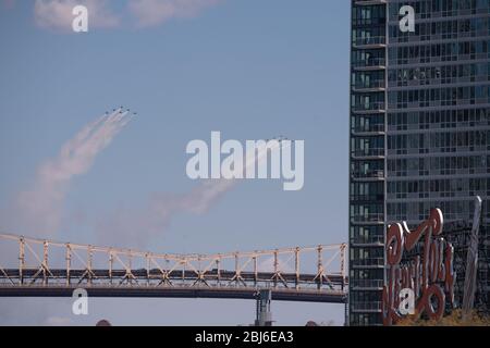 NEW YORK, NY - APRIL 28, 2020: The U.S. Navy's Blue Angels and U.S. Air Force's Thunderbirds jets perform a flyover New York City. Stock Photo