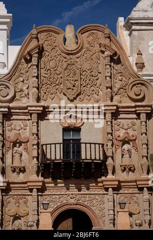 A close-up of the facade above the door of Mission San Xavier del Bac is a historic Spanish Catholic mission founded in 1692, known as the White Dove Stock Photo
