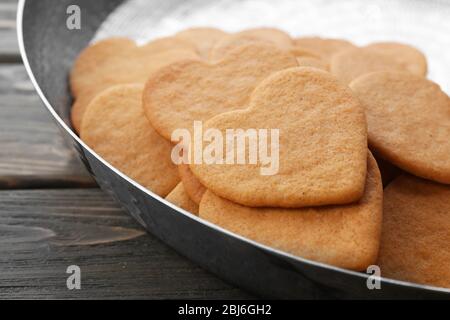 Heart shaped biscuits in baking tray, closeup Stock Photo