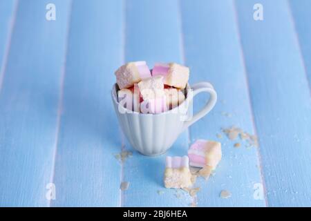 Tasty marshmallows with chocolate in cup on table, close up Stock Photo