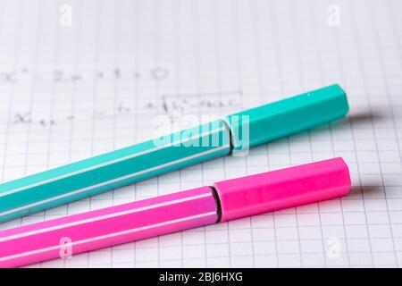 two highlighters on school graph paper with math equation Stock Photo